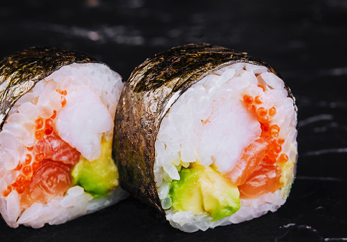 Traditional fresh japanese sushi futomaki on black stone