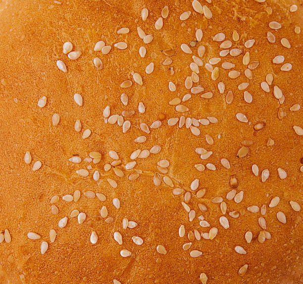 istock Fresh burger bun with sesame seeds close up on top view 2062723986