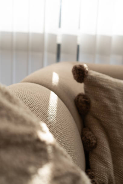 istock Sun beam through curtains hitting sofa in beige modern living space 2062734687