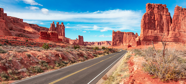 Scenic road in the red rock canyons. Arches National Park, Moab, Utah, United States. Adventure Travel.