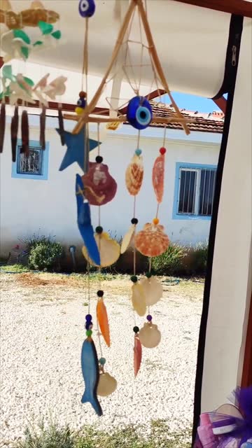 Seashells suspended on a rope, colorful wind chimes