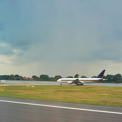 Logan International Airport, Boston Massachusetts, USA - October 2023.  Aircraft on the hard standing and the runway at the airport.