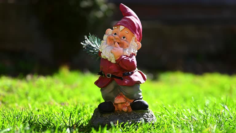 Garden Glimpses: Enchanting Gnome in Red Amidst Blurred Backyard Greenery - 4k