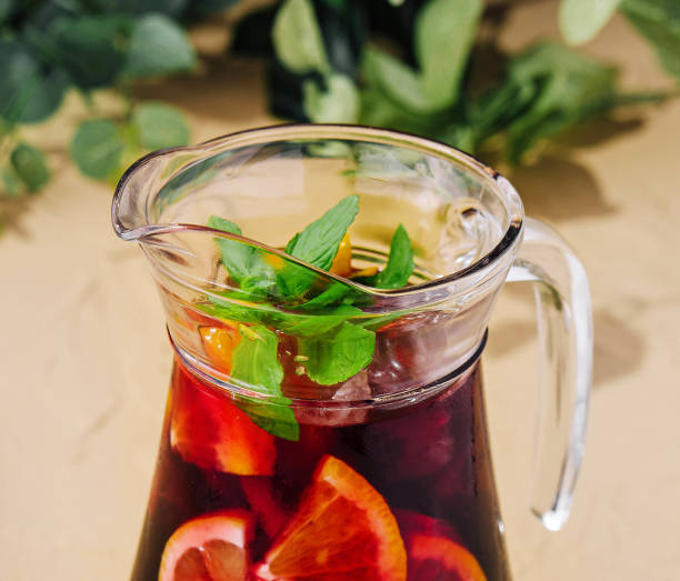 istock Full jug of pomegranate juice with lemon 2062765835