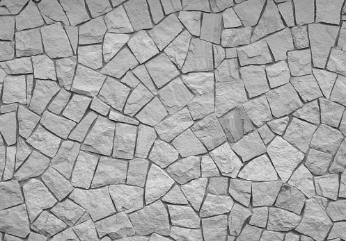 A wall made of pieces of decorative stone in black and white