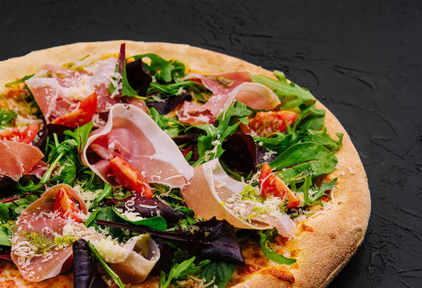 istock Pizza with prosciutto, arugula and parmesan 2062773819