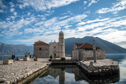 Perast, Montenegro – January 15, 2024: the Lady of the Rock Island in Perast, Montenegro, with magnificent mountain views from the wonderful Adriatic Sea