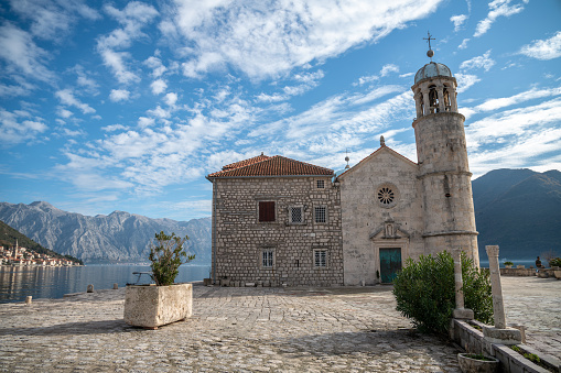 Perast, Montenegro – January 15, 2024: The Lady of the Rocks Island with mountain views in the wonderful Adriatic Sea in Perast, Montenegro