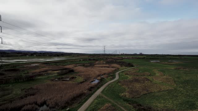 Drone shot of the WWT Steart Marshes nature reserve at sunset in Bridgwater, England, United Kingdom
