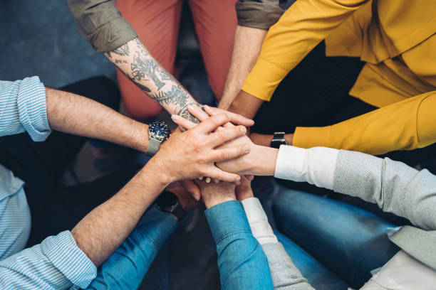 istock Above view of group of five people stacking hands 2062787923