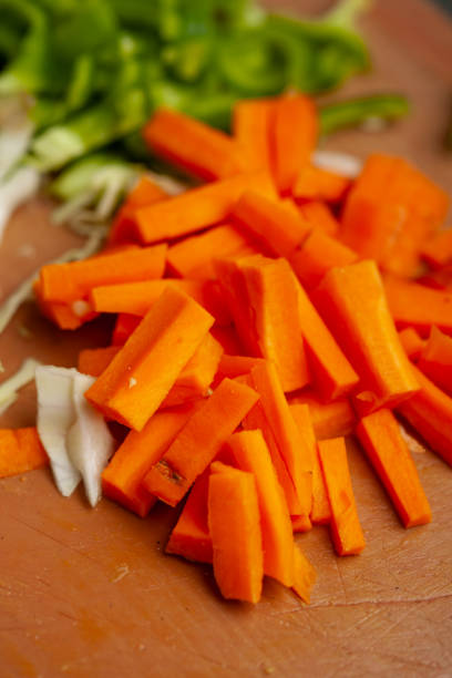 istock Freshly chopped carrots on a wooden cutting board 2062792117