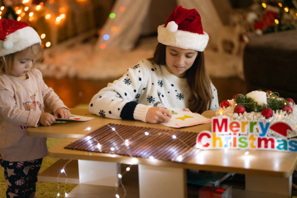 istock Two sisters make Christmas cards for their family 2062792920