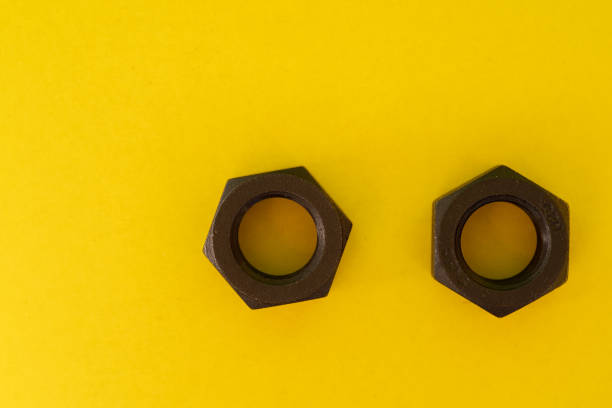 Bolts and nuts on yellow background