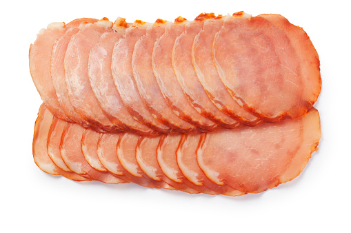 Studio shot of sliced Lomo, air dried Spanish pork loin with paprika and garlic cut out against a white background