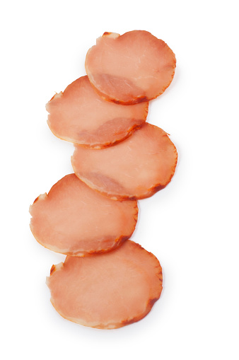 Studio shot of sliced Lomo, air dried Spanish pork loin with paprika and garlic cut out against a white background