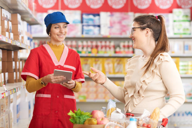 istock Supermarket clerk helping a customer and smiling 2062815224