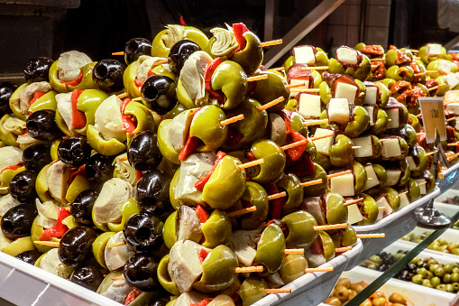 Tapas and pinchos at a food market in Spain. Traditional Spanish gastronomy. Finger food, travelling in Europe