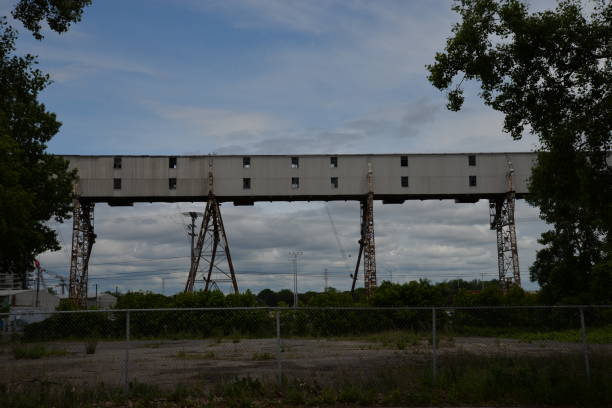 istock Vast bridge spans a verdant field under cloudy skies 2062831708