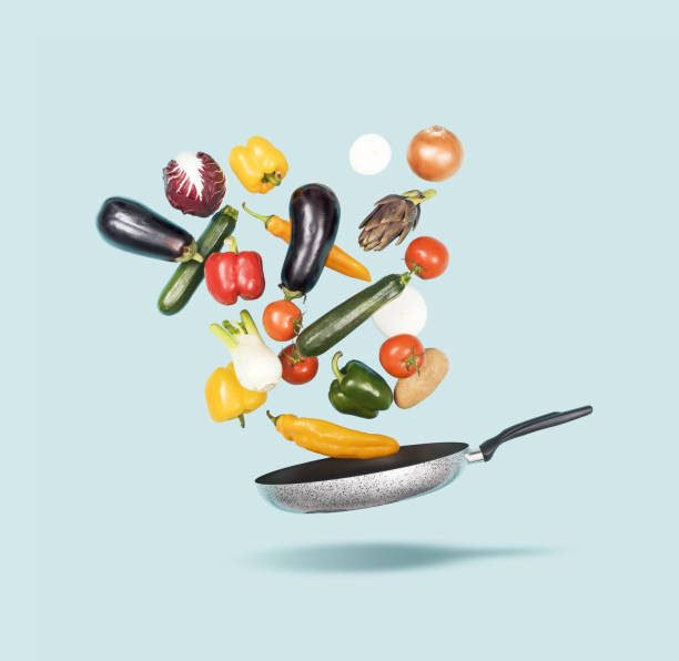 istock Fresh healthy vegetables falling in a pan 2062832750