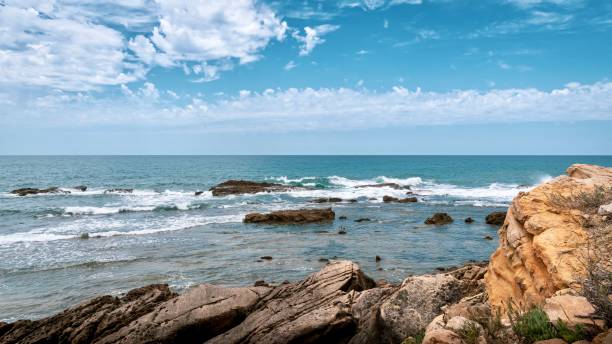 istock Scenic view of a rocky beach on a sunny day 2062842380