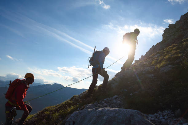 Group of mountaineers climbing up the hill stock photo