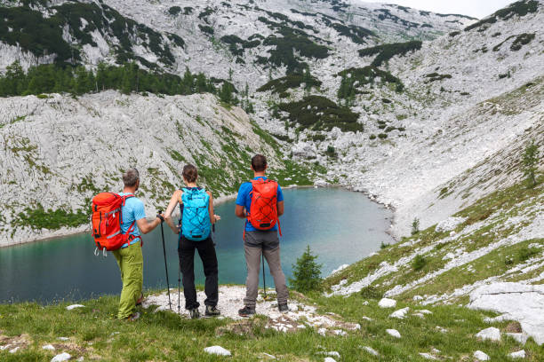 istock Three mountain climbers near the mountain lake 2062844502