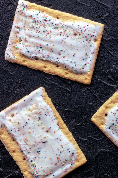 istock Pop tarts on black. Poptart toaster pastry with icing, shot from above 2062850891