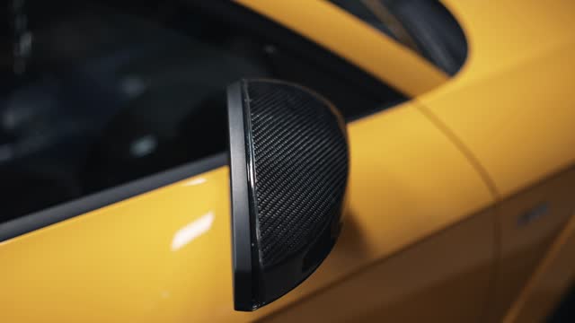 Expanding Carbon fiber side mirror on luxury yellow car