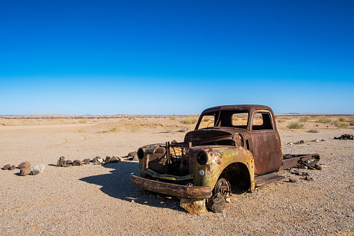 Solitaire, Namibia - March 29, 2019 : Abandoned car wrecks near the Solitaire service station located in the Namib Desert of Namibia.