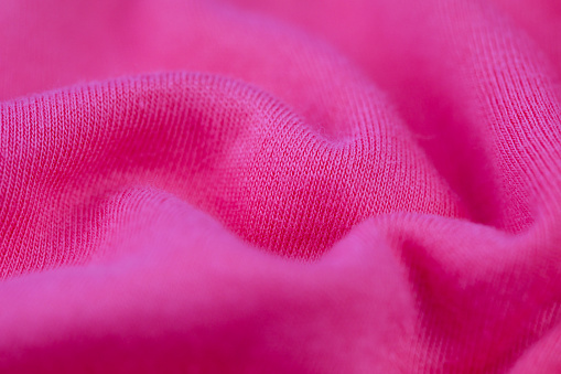 A closeup of a pink soft fabric texture