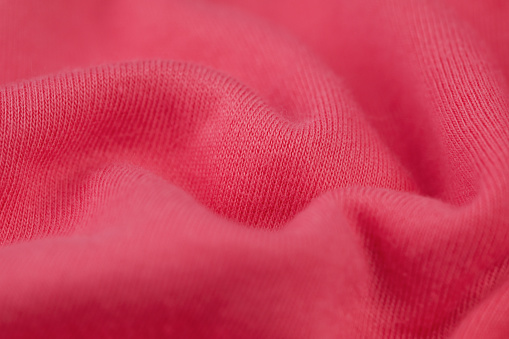 A closeup of a pink soft fabric texture
