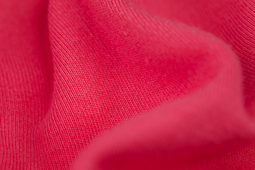 A closeup of a pink soft fabric texture