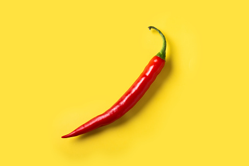 Red hot chili peppers on yellow background