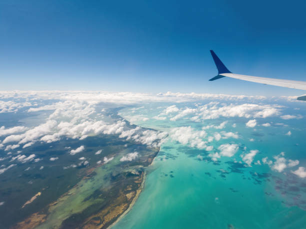 istock Airplane flying above ocean with clouds and sea below 2062891101