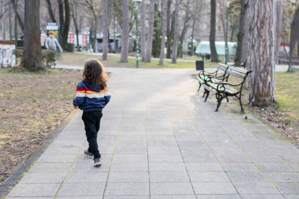 Little boy is having fun and playing in the public park.