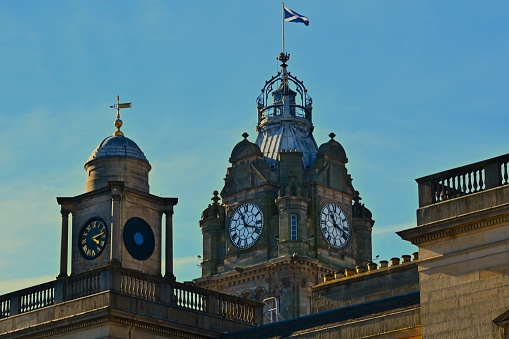 A view of a prominent clock tower building in the heart of the city of Edinburgh.