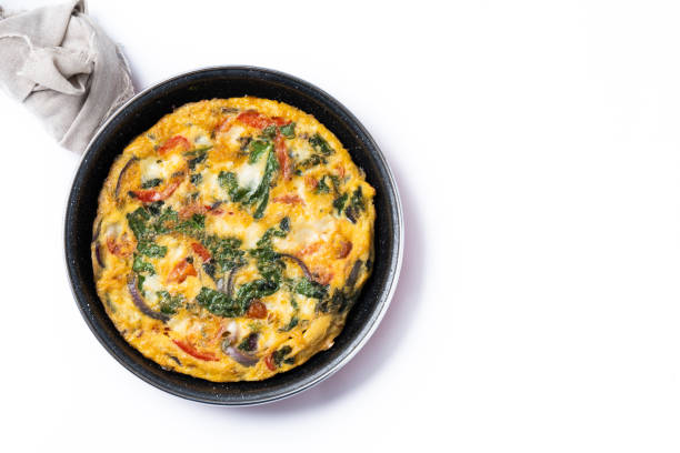 istock Fritatta made with spinach, tomatoes, onion and peppers on marble background 2062901641