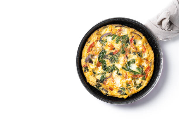 istock Fritatta made with spinach, tomatoes, onion and peppers on marble background 2062902157