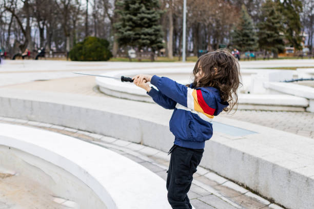 Little boy is having fun and playing in the public park.