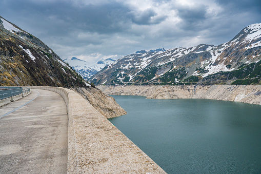 Kölnbrein Dam and the Koelnbreinspeicher reservoir in the Maltatal Carinthia Austria during an overcast springtime day in the Hohe Tauern range in the Alps.