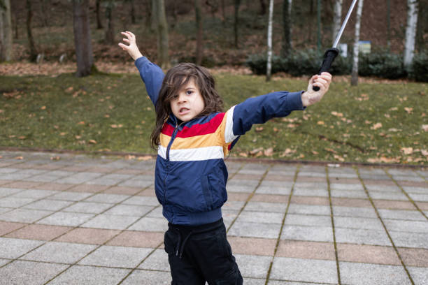 istock Little boy is having fun and playing in the public park, making funny faces. 2062913910