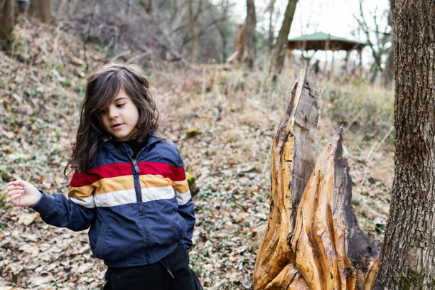 istock Little boy is having fun and playing in the public park, making funny faces. 2062916760