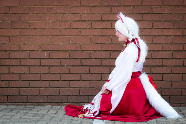 Female cosplayer in feline priestess attire at a convention