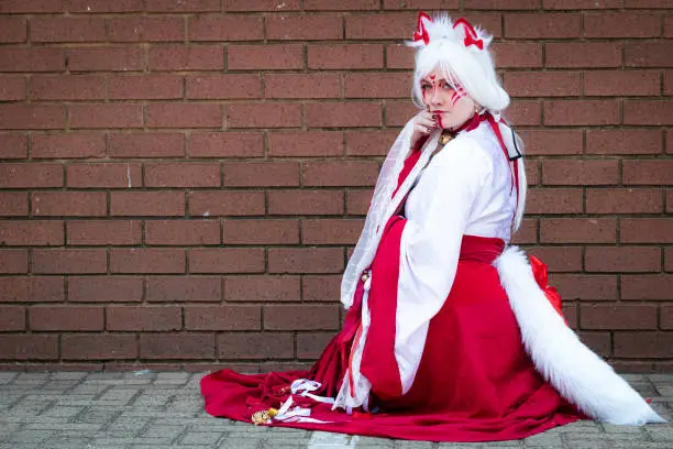 Female cosplayer in feline priestess attire at a convention