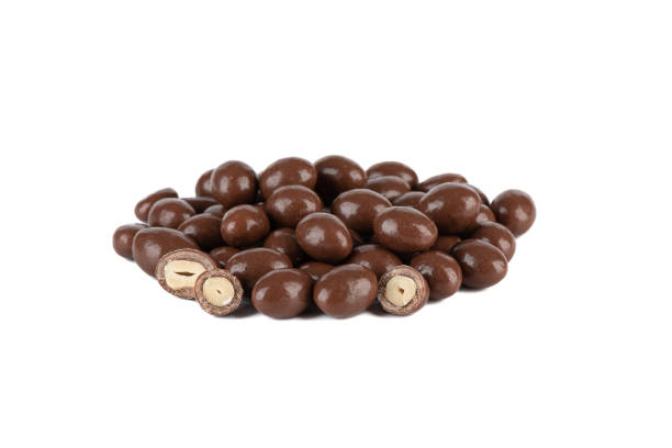 istock A pile of dark chocolate covered peanuts on a white background. 2062917806