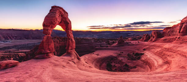 istock a stone arch in the desert with mountains and blue sky 2062918391