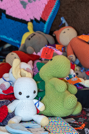 Assortment of crocheted toys displayed on a sofa