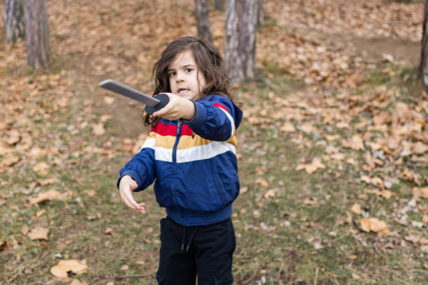 istock Little boy is having fun and playing in the public park, making funny faces. 2062929772