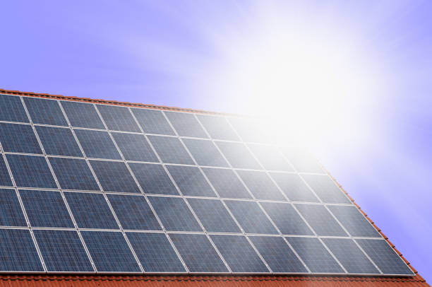 Photovoltaic energy solar panels in sunny day on blue sky background