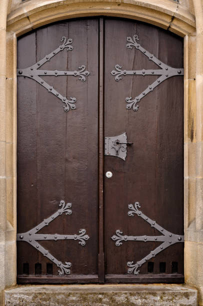 istock wooden doors with wrought designs open in a stone building, 2062933616